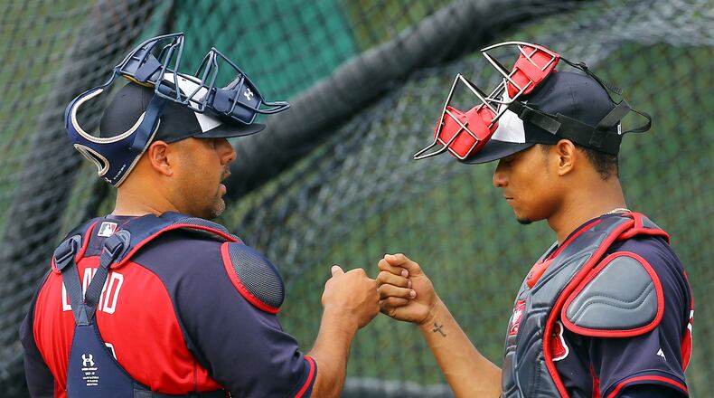 022114 LAKE BUENTA VISTA: Braves catchers Gerald Laird and Christian Bethancourt bump knuckles at the conclusion of catching drills during spring training on Friday, Feb. 21, 2014, in Lake Buena Vista, FL. CURTIS COMPTON / CCOMPTON@AJC.COM If Gerald Laird (left) and Christian Bethancourt are Braves' top catchers, Evan Gattis would move to outfield. (Curtis Compton)