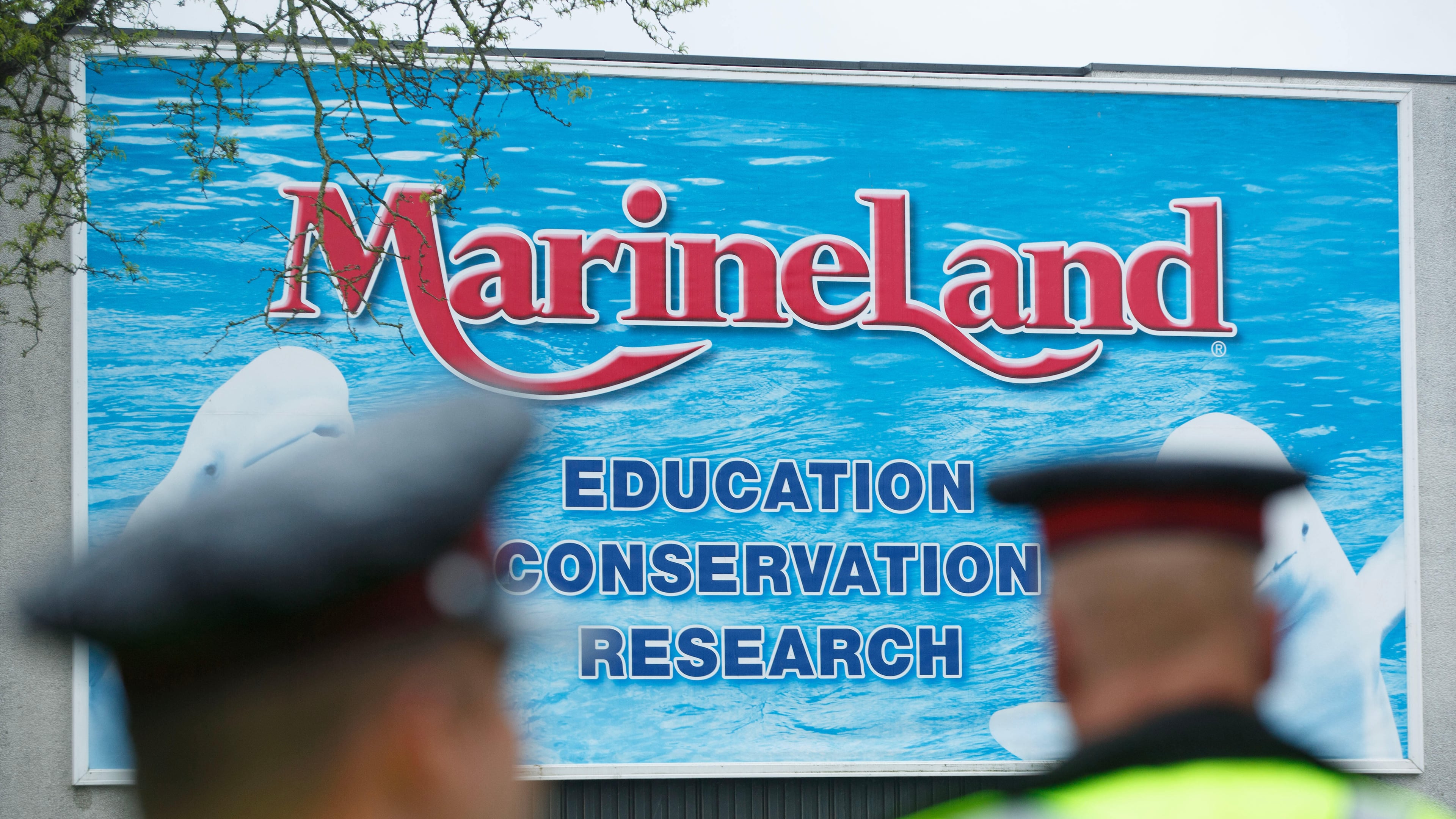 Police officers block protestors from an entrance to Marineland grounds in Niagara Falls, Ontario, Canada, on May 20, 2023. (Alex Lupul/The Canadian Press via AP)