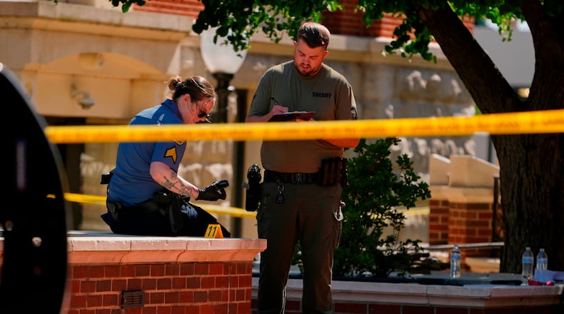 Sheriff's deputies investigate a shooting scene outside the Montgomery County Courthouse, Wednesday, May 13, 2026, in Clarksville, Tenn. (AP Photo/George Walker IV)