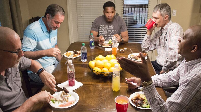 A group of members from different churches in Georgia meet for supper at participant Eddie L. Johnson’s house in Alpharetta on Monday night to participate in the “Conversations” movement, a series of joint discussions about race. Lee Jenkins, senior pastor at Eagles Nest Church in Roswell, center, leads the discussion with Stephen Gilkenson, George Dempsey, Matthew Hendley and Eddie L. Johnson, left to right. (Jenna Eason / Jenna.Eason@coxinc.com)