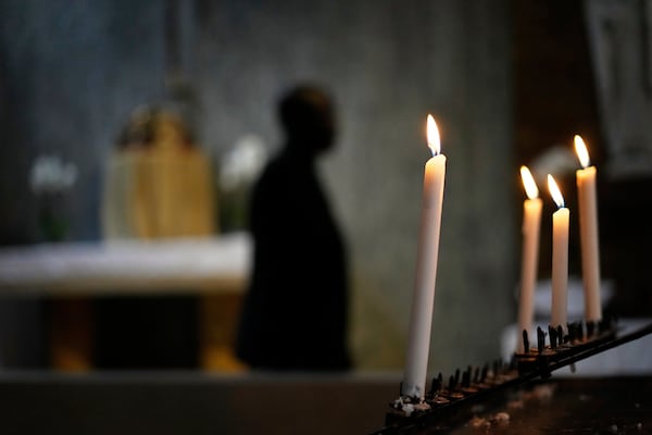 A man walks past prayer candles following Pope Francis Memorial Mass, at the Cathedral of Christ the King, Johannesburg, South Africa, Wednesday, April 23, 2025. (AP Photo/Themba Hadebe)