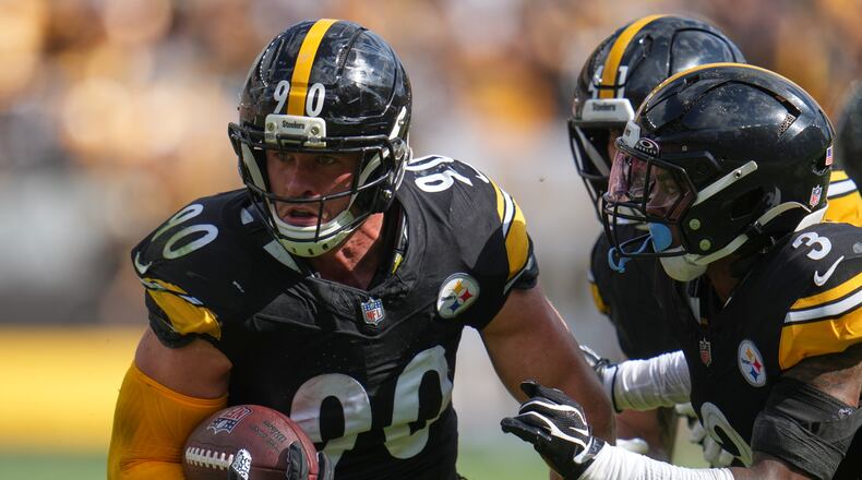 Pittsburgh Steelers outside linebacker T.J. Watt (90) returns an interception in for a touchdown during an NFL football game, Sunday, Sept. 13, 2026, in Pittsburgh. (AP Photo/Gene J. Puskar)