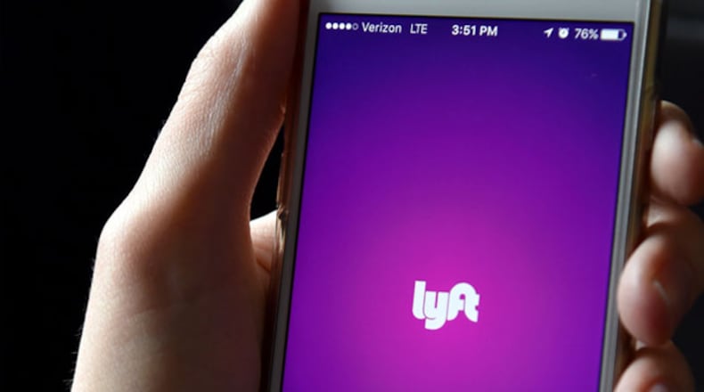 FILE PHOTO: The Lyft app is seen on a passenger's phone. (Photo by Mike Coppola/Getty Images for Lyft)