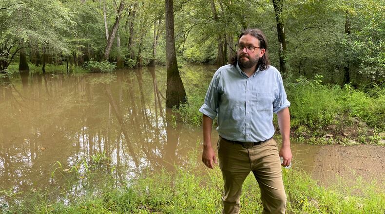 FILE - Seth Clark, then mayor pro-tem of Macon, walks in the Bond Swamp National Wildlife Refuge in Round Oak, Ga., on Aug. 22, 2022. (AP Photo/Michael Warren, File)