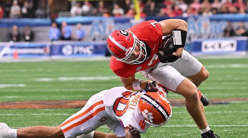 Clemson cornerback Avieon Terrell (bottom) — pictured tackling Georgia tight end Lawson Luckie in 2024 — was picked No. 48 overall by the Falcons in the 2026 NFL draft. (Hyosub Shin/AJC 2024)