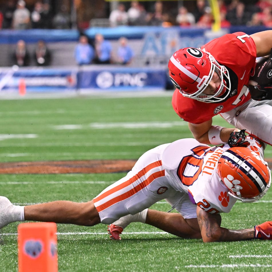 Clemson cornerback Avieon Terrell (bottom) — pictured tackling Georgia tight end Lawson Luckie in 2024 — was picked No. 48 overall by the Falcons in the 2026 NFL draft. (Hyosub Shin/AJC 2024)