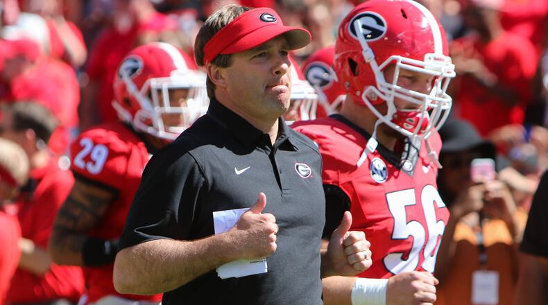 Georgia head coach Kirby Smart runs into Sanford Stadium with the team during the Bulldogs' G-Day spring football game Saturday, April 16, 2016 in Athens.
