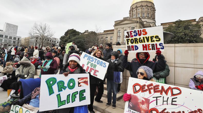 Demonstrators who support abortion rights and others who oppose abortion display their signs in March at the Georgia Capitol in Atlanta. (ALYSSA POINTER/ALYSSA.POINTER@AJC.COM)