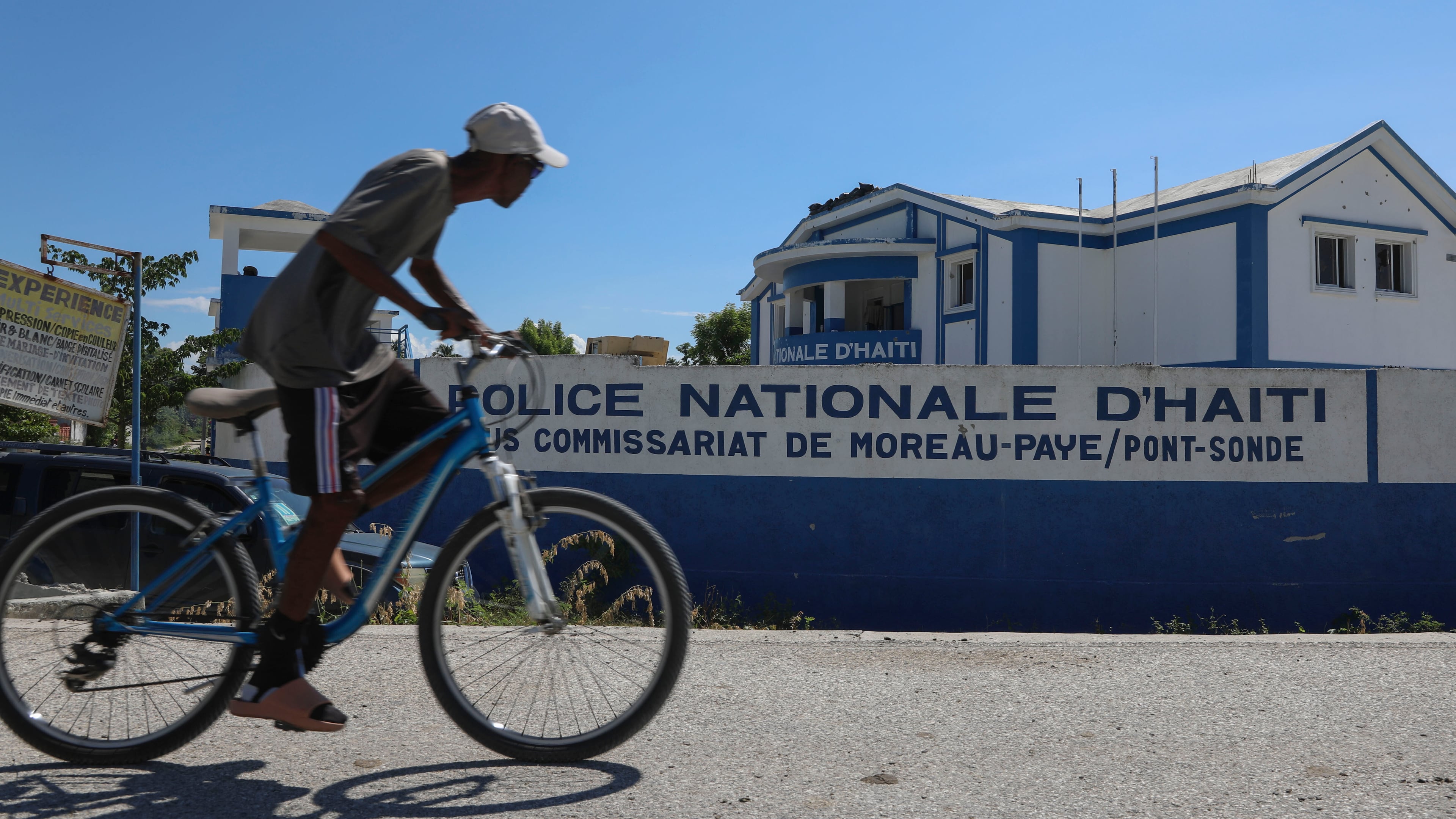FILE - A man rides his bicycle past police station in Pont-Sonde, Haiti, Oct. 7, 2024. (AP Photo/Odelyn Joseph, File)
