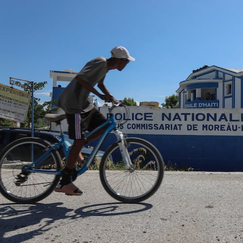 FILE - A man rides his bicycle past police station in Pont-Sonde, Haiti, Oct. 7, 2024. (AP Photo/Odelyn Joseph, File)