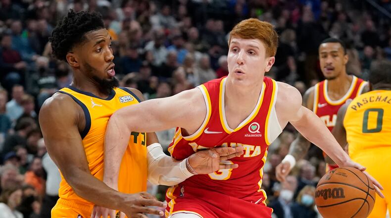 Utah Jazz guard Donovan Mitchell, left, guards Atlanta Hawks guard Kevin Huerter duirng the first half of an NBA basketball game Tuesday, Nov. 9, 2021, in Salt Lake City. (AP Photo/Rick Bowmer)