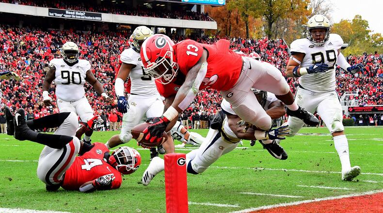 Elijah Holyfield of the Georgia Bulldogs scores a touchdown against the Georgia Tech Yellow Jackets on November 24, 2018 at Sanford Stadium in Athens. (Photo by Scott Cunningham/Getty Images)