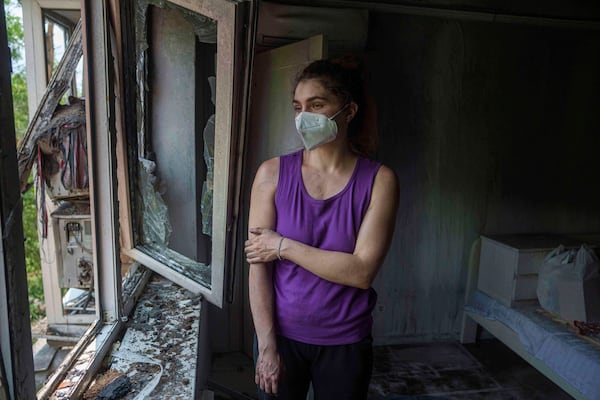 Karyna Holf, 25, stands in her apartment which was damaged by a Russian drone strike in Kyiv, Ukraine, on Thursday, July 10, 2025. (AP Photo/Evgeniy Maloletka)