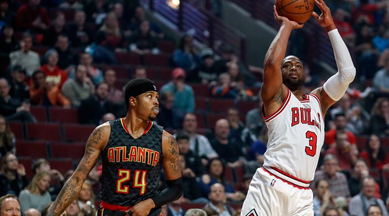 Chicago Bulls guard Dwyane Wade (3) shoots, scores and is fouled on the play by Atlanta Hawks forward Kent Bazemore (24) during the first half of an NBA basketball game, Wednesday, Jan. 25, 2017, in Chicago. (AP Photo/Kamil Krzaczynski)