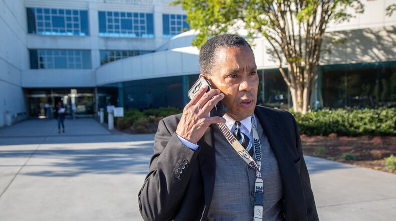 Gwinnett’s solicitor general, Brian Whiteside, takes phone call while leaving the Gwinnett Justice and Administration Center. (Photo by Phil Skinner) AJC FILE PHOTO