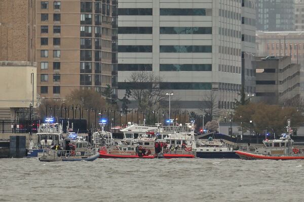 As seen from Pier 40 in New York, police and and fire crews from New York and New Jersey respond to the scene where a helicopter crashed into the Hudson River, Thursday, April 10, 2025, in Jersey City, N.J. (AP Photo/Yuki Iwamura)