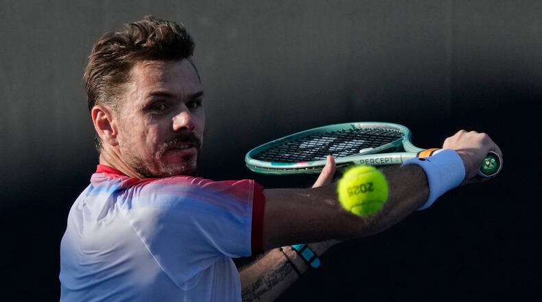 FILE - Stan Wawrinka, of Switzerland, plays a backhand return to Lorenzo Sonego, of Italy, during a first-round match at the Australian Open tennis championship in Melbourne, Australia, Jan. 14, 2025. (AP Photo/Manish Swarup, File)