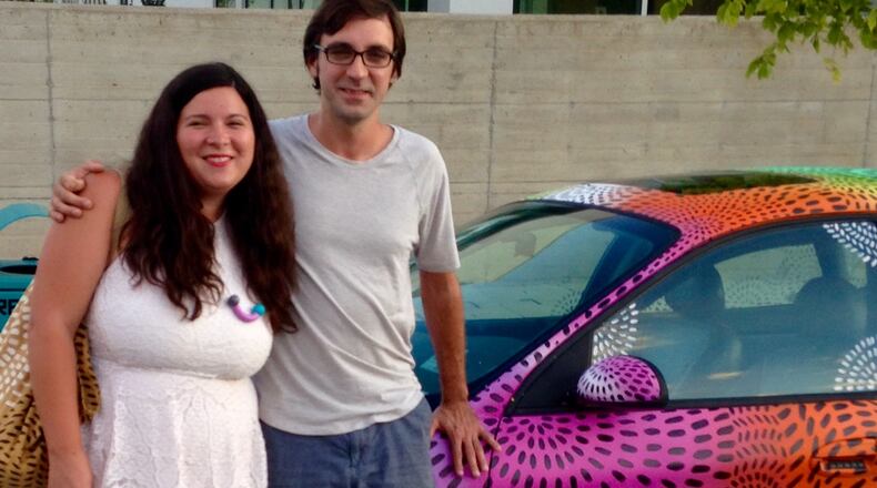 Artists Felici Asteinza and Joey Fillastre, who will paint the mural covering the MARTA overpass at Decatur’s West Trinity Place and Atlanta Avenue. Their car has similar motifs to their proposed mural. Bill Banks For the AJC.