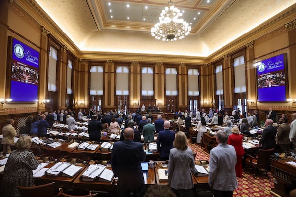 Members of the Georgia House of Representatives stand for the national anthem to start the final day of the legislative session in April. (Jason Getz/AJC) 