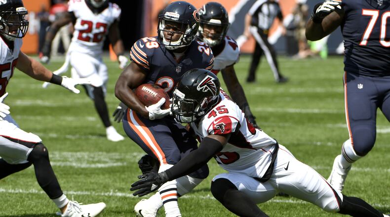 CHICAGO, IL - SEPTEMBER 10:   Deion Jones #45 of the Atlanta Falcons atempts to tackle  Tarik Cohen #29 of the Chicago Bears in the first quarter at Soldier Field on September 10, 2017 in Chicago, Illinois.  (Photo by David Banks/Getty Images)