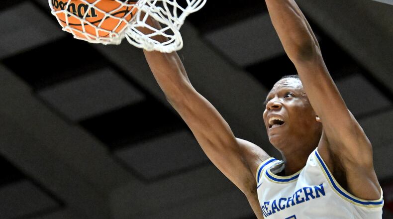 McEachern's Ace Bailey (4) dunks the ball during the first half of GHSA Basketball Class 7A Girl’s State Championship game at the Macon Centreplex, Saturday, Mar. 9, 2024, in Macon. (Hyosub Shin / Hyosub.Shin@ajc.com)