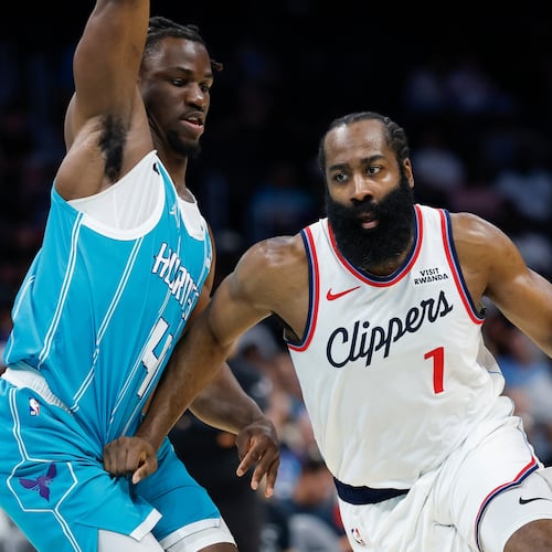 Los Angeles Clippers guard James Harden, right, drives to the basket against Charlotte Hornets guard Sion James during the first half of an NBA basketball game in Charlotte, N.C., Saturday, Nov. 22, 2025. (AP Photo/Nell Redmond)
