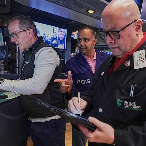 Specialist Glenn Carell, left, and Dilip Patel, center, work with trader Jeffrey Vazquez on the floor of the New York Stock Exchange, Friday, June 26, 2026. (AP Photo/Richard Drew)