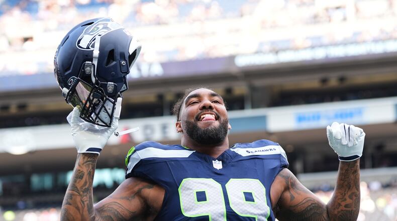 Seattle Seahawks' Leonard Williams responds to fans during warmups before an NFL preseason football game against the Dallas Cowboys, Saturday, Aug. 15, 2026, in Seattle. (AP Photo/Lindsey Wasson)