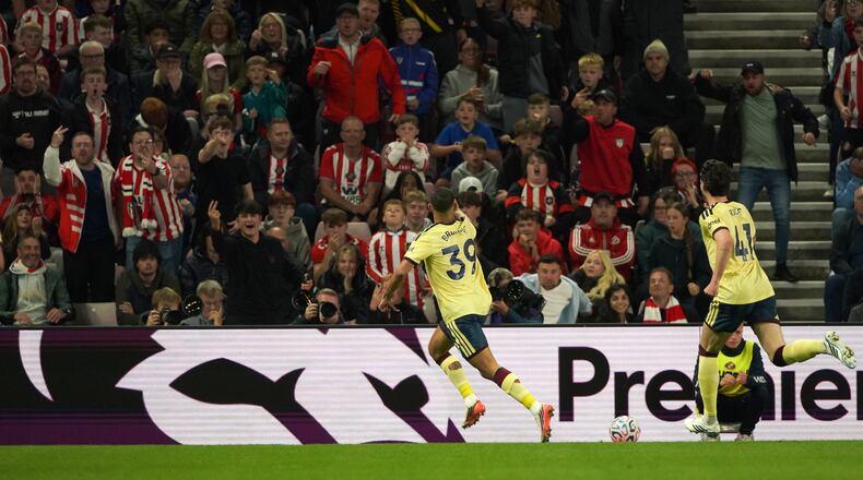 Arsenal's Bruno Guimaraes, center, celebrates after scoring the opening goal during the English Premier League soccer match between Sunderland and Arsenal in Sunderland, England, Saturday, Sept. 12, 2026. (AP Photo/Ian Hodgson)