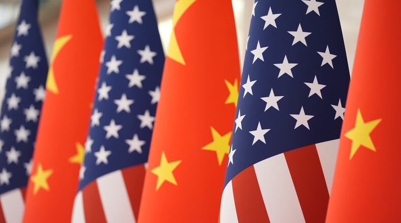 FILE - The U.S. and Chinese flag at the Great Hall of the People prior to the state dinner of President Donald Trump and Chinese President Xi Jinping on May 14, 2026, in Beijing. (AP Photo/Mark Schiefelbein, File)