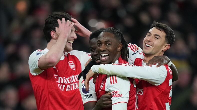 Arsenal's Eberechi Eze , centerm smiles after scoring during a Premier League soccer match between Arsenal and Tottenham in London, Sunday, Nov. 23, 2025. (AP Photo/Frank Augstein)
