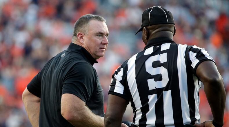 Georgia State coach Shawn Elliott talks with an official during the second half of an NCAA college football game against Auburn Saturday, Sept. 25, 2021, in Auburn, Ala. (AP Photo/Butch Dill)