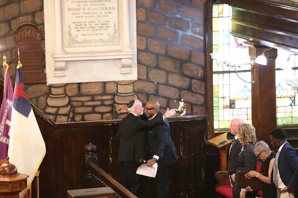 Tree of Life synagogue Rabbi Jeff Myers, left, and Mother Emanuel AME pastor The Rev. Eric S.C. Manning, right, hug after Myers spoke at a commemoration of the 10th anniversary of the Charleston Church Massacre at Mother Emanuel on Tuesday, June 17, 2025, in Charleston, S.C. (AP Photo/Jeffrey Collins)