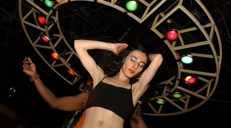 Nadia Gabrielli boogied down with her dance partner DeAngelo Isom, rear, at the gay-oriented Ponce de Leon Avenue nightclub MJQ Concourse in 2002. (SUNNY SUNG/STAFF)