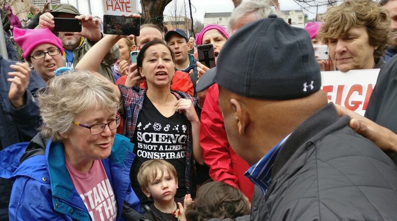 Rep. John Lewis, who headlined Saturday’s women’s march, speaks with demonstrators.