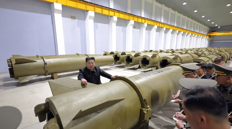 In this photo provided by the North Korean government, its leader Kim Jong Un, center, visits a weapons factory at an undisclosed place in North Korea Saturday, June 6, 2026. Independent journalists were not given access to cover the event depicted in this image distributed by the North Korean government. The content of this image is as provided and cannot be independently verified. Korean language watermark on image as provided by source reads: "KCNA" which is the abbreviation for Korean Central News Agency. (Korean Central News Agency/Korea News Service via AP)