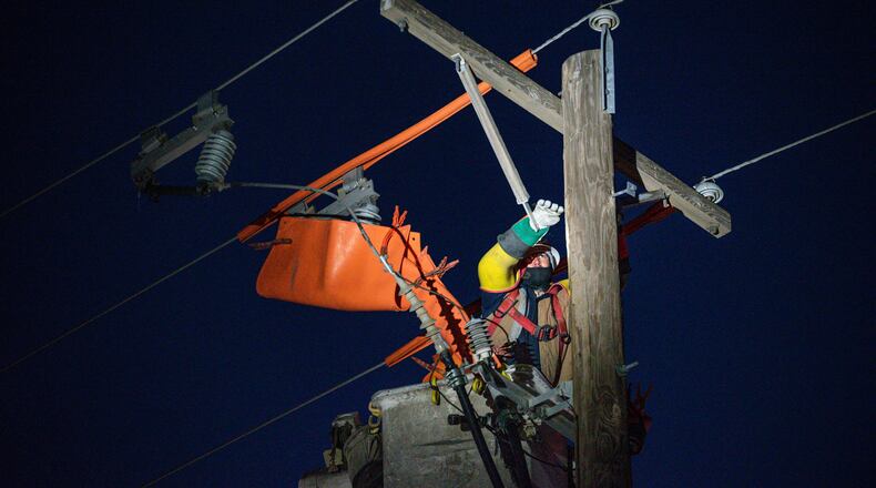 FILE - Oncor apprentice lineman Brendan Waldon repairs a utility pole that was damaged by a winter storm on Feb. 18, 2021, in Odessa, Texas. (Eli Hartman/Odessa American via AP, File)