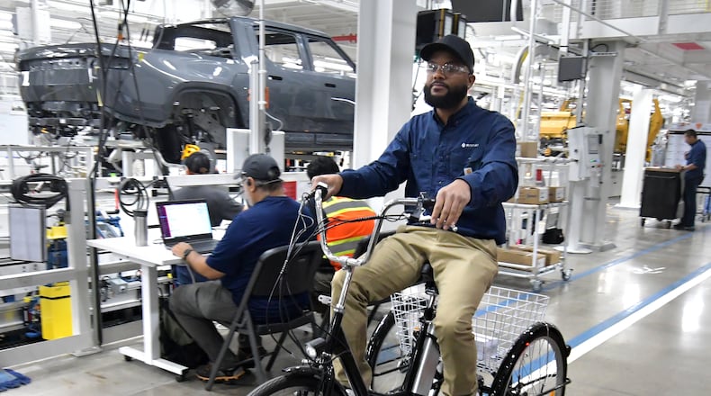 Manufacturing workers assemble electric vehicles at Rivian in Normal, Ill., on July 20, 2022. (Photo for The Atlanta Journal-Constitution by Ron Johnson)
