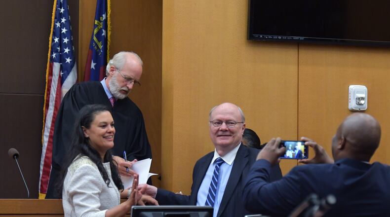 August 14, 2018 Atlanta - Meria Carstarphen, superintendent of Atlanta Public Schools (left), and attorney Charles Huddleston pose in front of Judge Alan Harvey (background) after ruling to allow Fulton County to collect tax money on Tuesday, August 14, 2018. HYOSUB SHIN / HSHIN@AJC.COM