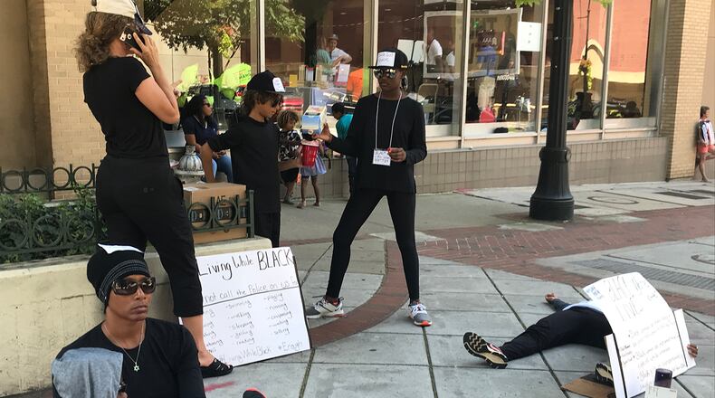 A silent protest is held outside as part of the Road to Change Rally presented by March For Our Lives at the Rialto Center for the Arts at Georgia State University on Sunday, July 29, 2018. (Photo by Eric Stirgus / AJC)