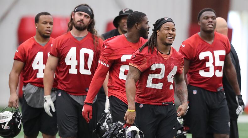 May 22, 2018 Flowery Branch: Atlanta Falcons offensive players Demario Richard (from left), Daniel Marx, Tevin Coleman, Devonta Freeman, and Malik Williams head to the next drill during organized team activities on Tuesday, May 22, 2018, in Flowery Branch. Curtis Compton/ccompton@ajc.com