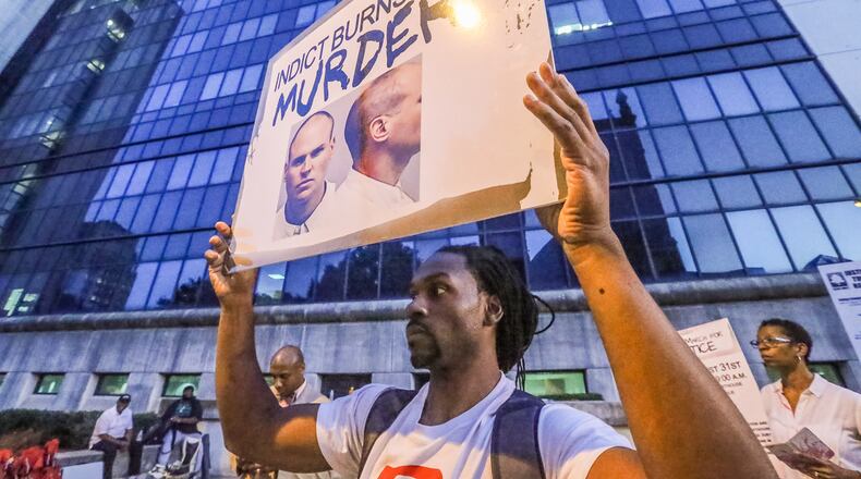 Protesters advocate for an indictment surrounding the officer-related killing of Deravis Caine Rogers Wednesday August 31, 2016 in front of the Fulton County Courthouse.
