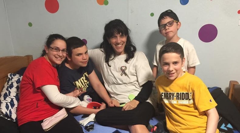 Rivkah Eidex, center, in a bittersweet moment with Effie, second from left, and his siblings before returning home to Decatur. Eidex, no longer able to care for Effie, who has severe autism, recently placed him in a residential treatment program where he can receive 24/7 care. Contributed