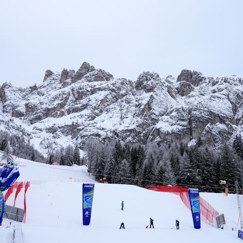 Race officials prepare the course ahead of an alpine ski, women's downhill official training, at the 2026 Winter Olympics, in Cortina d'Ampezzo, Italy, Friday, Feb. 6, 2026. (AP Photo/Giovanni Auletta)