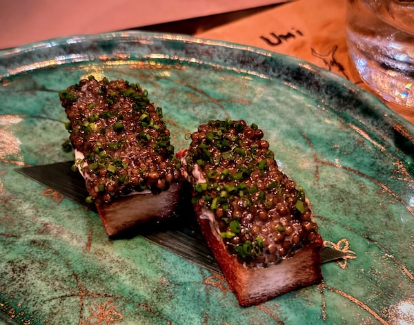 Umi offers caviar toast with creme fraiche and chives. (Henri Hollis/AJC)