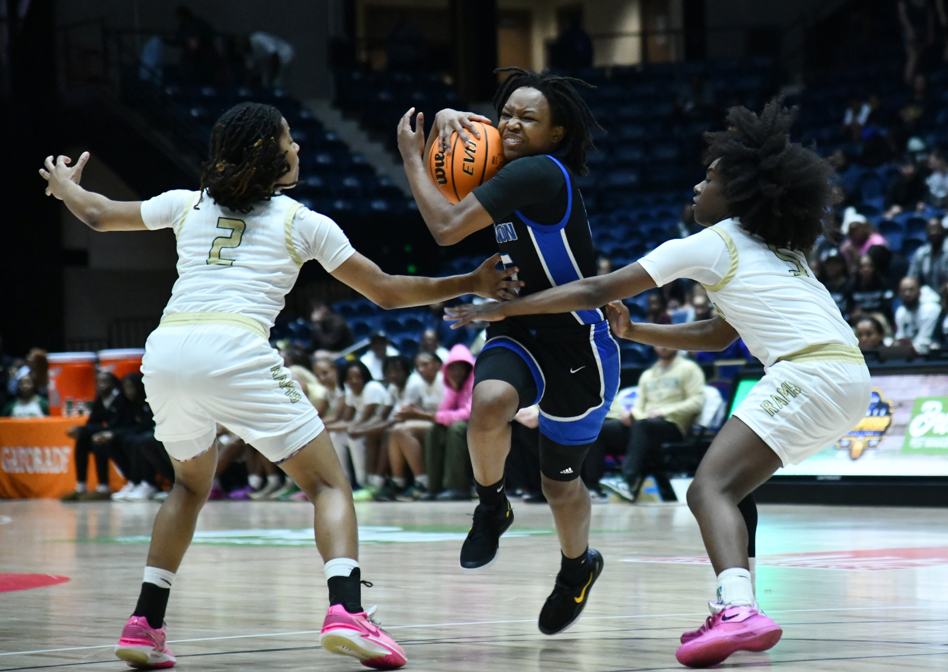 Newton's London Smith (center) drives against Grayson's Tatum Brown (2) and Grayson's Zoie Lofton (right) during the second half of the GHSA Girls 6A State Championship at the Macon Centreplex, Saturday, March 8, 2025, in Macon. Newton won 59-56 over Grayson. (Hyosub Shin / AJC)