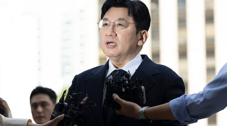 FILE - Bang Si-Hyuk, a chairman of Hybe, answers reporters' question upon his arrival at the Seoul Metropolitan Police Agency in Seoul, South Korea, on Sept. 15, 2025. (Kim Keun-soo/Newsis via AP, File)