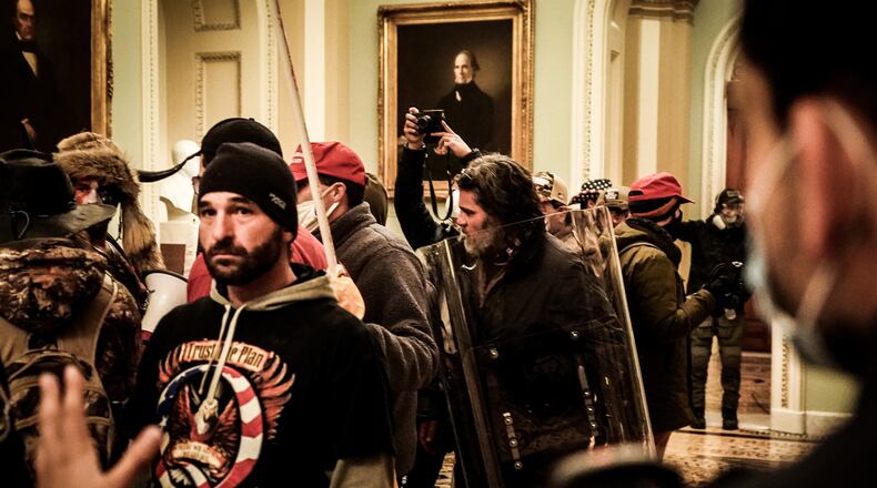 Rioters confront Capitol Police officers near the U.S. Senate chamber, inside the Capitol in Washington, Jan 6, 2021. The Proud Boy’s propensity for violence and extremism was no secret. But the F.B.I. and other agencies had often seen the Proud Boys as they chose to portray themselves, according to more than a half-dozen current and former federal officials: as mere street brawlers who lacked the organization or ambition of typical bureau targets like neo-Nazis, international terrorists and Mexican drug cartels. (Erin Schaff/The New York Times)