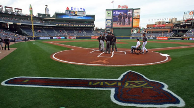 A freshly painted tomahawk is shown on the grass as former UGA second baseman Chance Veazey greets officials before the Atlanta Braves' exhibition game against the Chicago White Sox in an exhibition game at Turner Field Friday night in Atlanta, Ga., April 2, 2010. Veazey was paralyzed in an accident last fall.