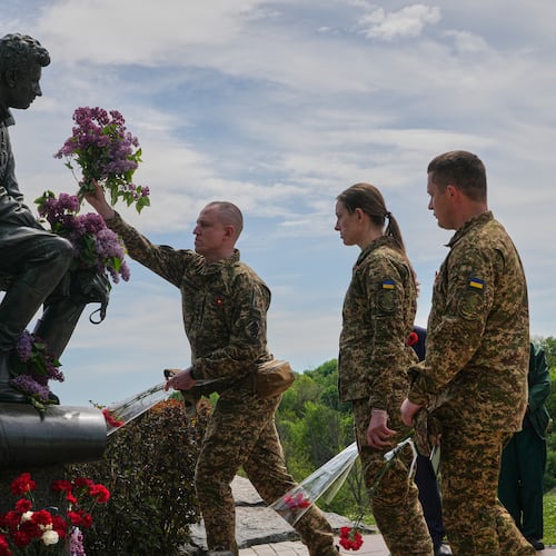 Ukrainian army officers lay flowers at a monument to pilots to mark Victory Day in World War II, in Kyiv, Ukraine, Friday, May 8, 2026, as the Russian attack on Ukraine continues. (AP Photo/Efrem Lukatsky)